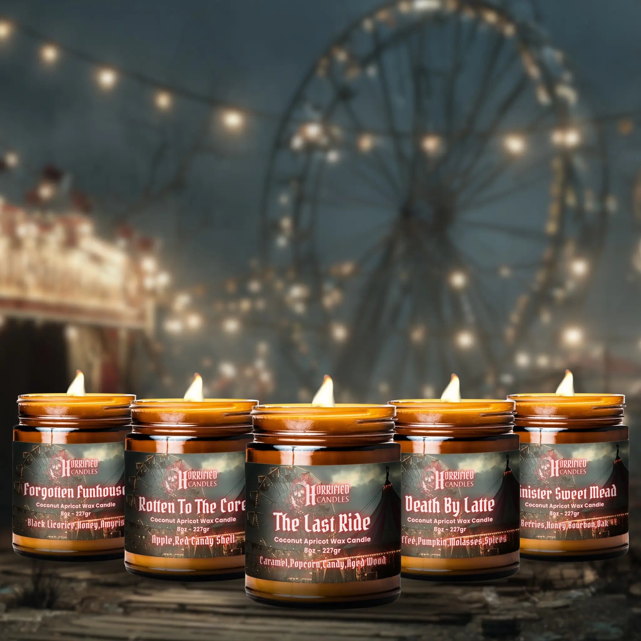 Row of candles with labels in front of a Ferris wheel at night