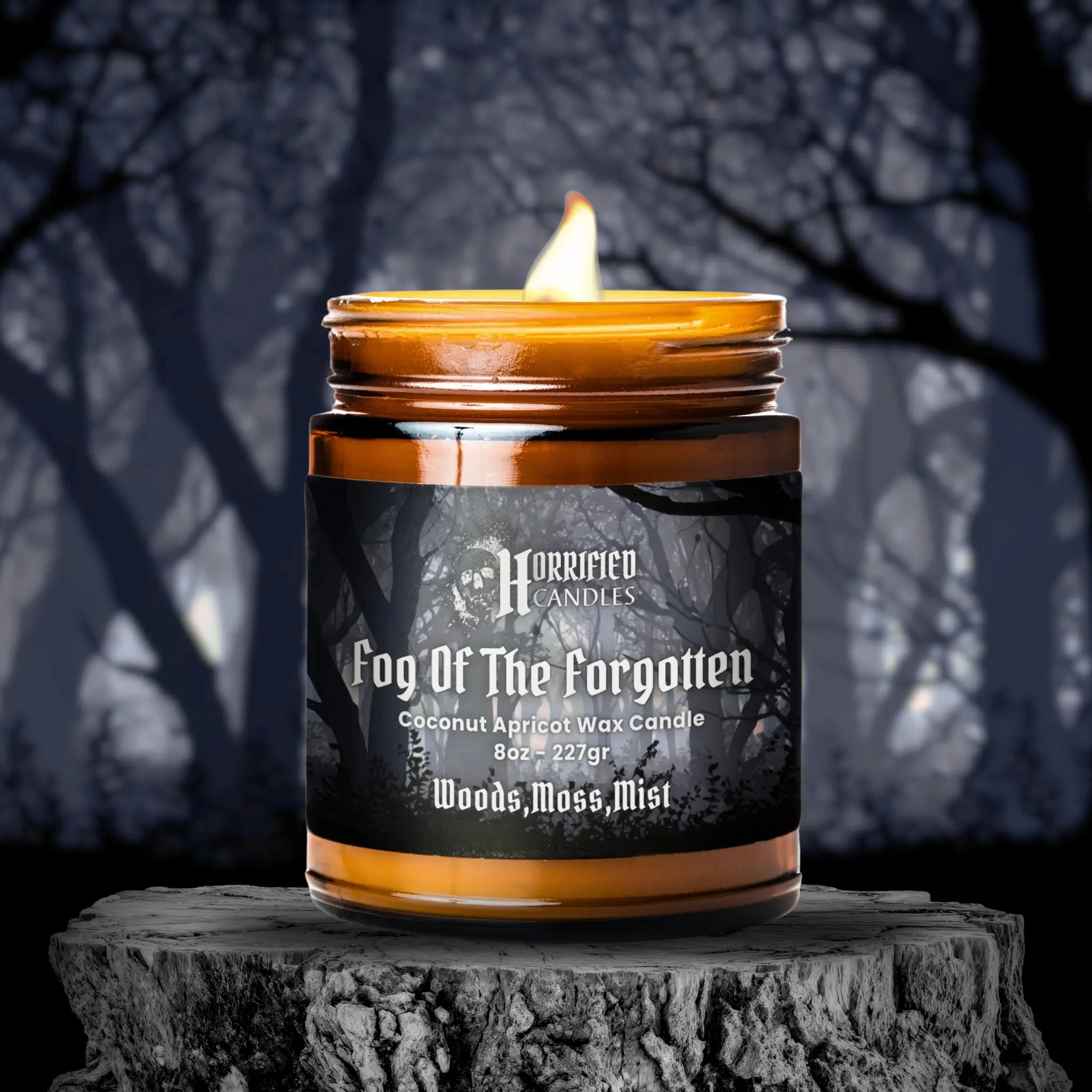 Candle labeled 'Fog Of The Forgotten' by Horrified Candles on a dark background