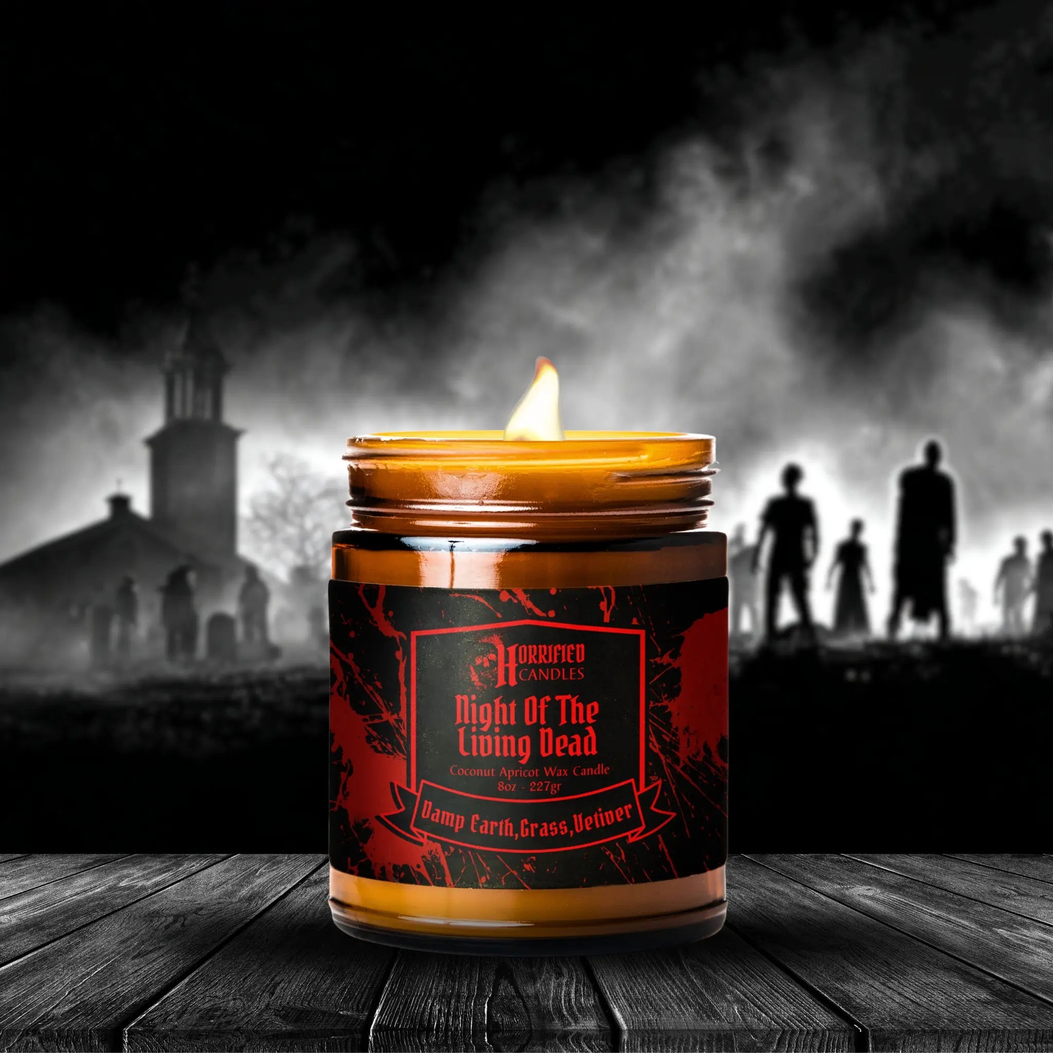 Candle with a dark label on a wooden surface, with a foggy silhouette of people and a building in the background.