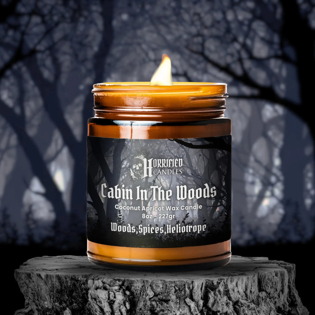Candle labeled 'Cabin In The Woods' by Horrified Candles on a dark background