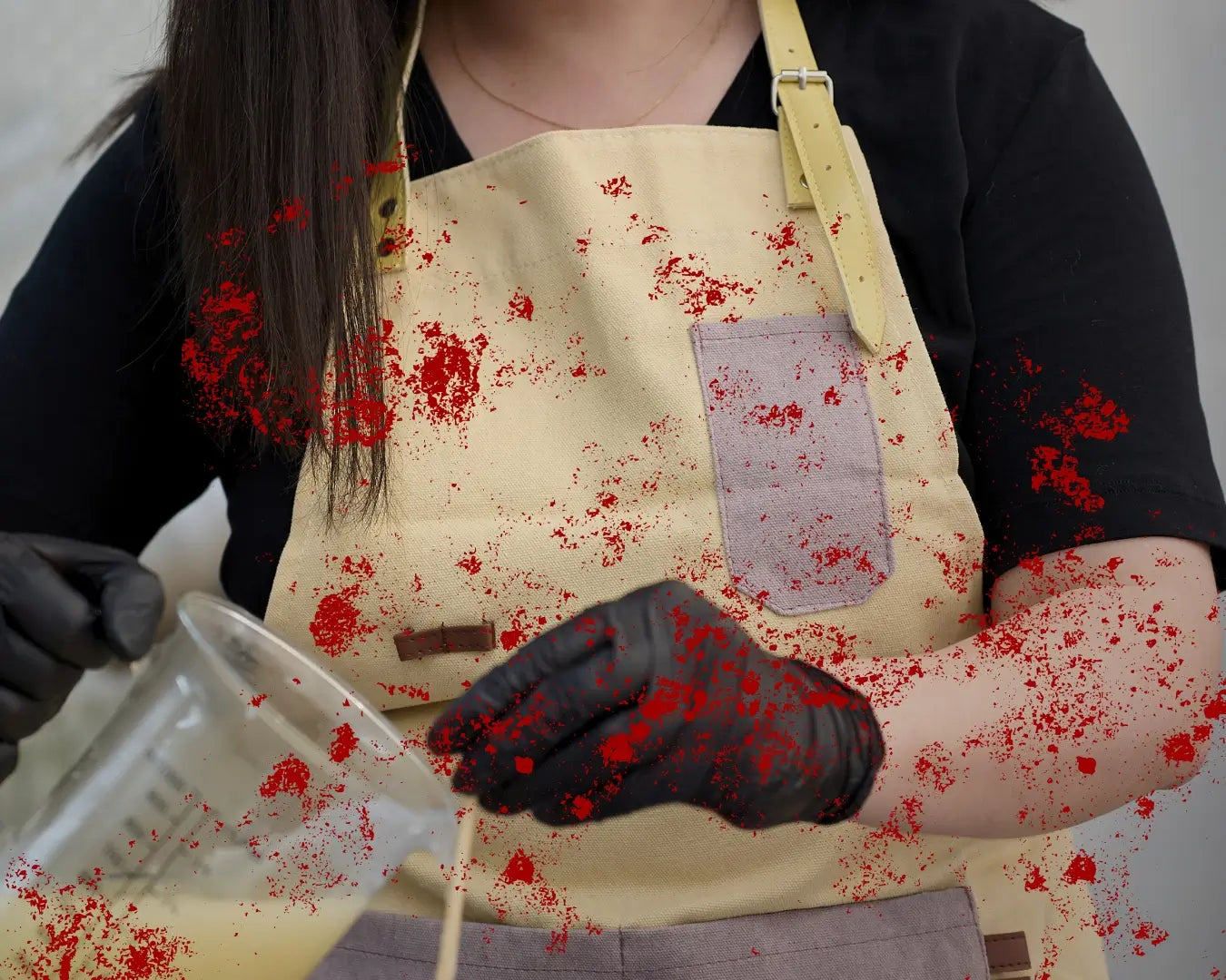Person wearing a blood-stained apron and gloves, holding a container with red liquid.