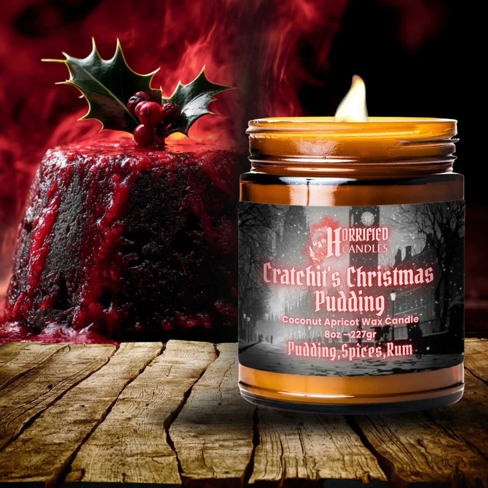 Candle labeled 'Grateful's Christmas Pudding' next to a Christmas pudding on a wooden surface.