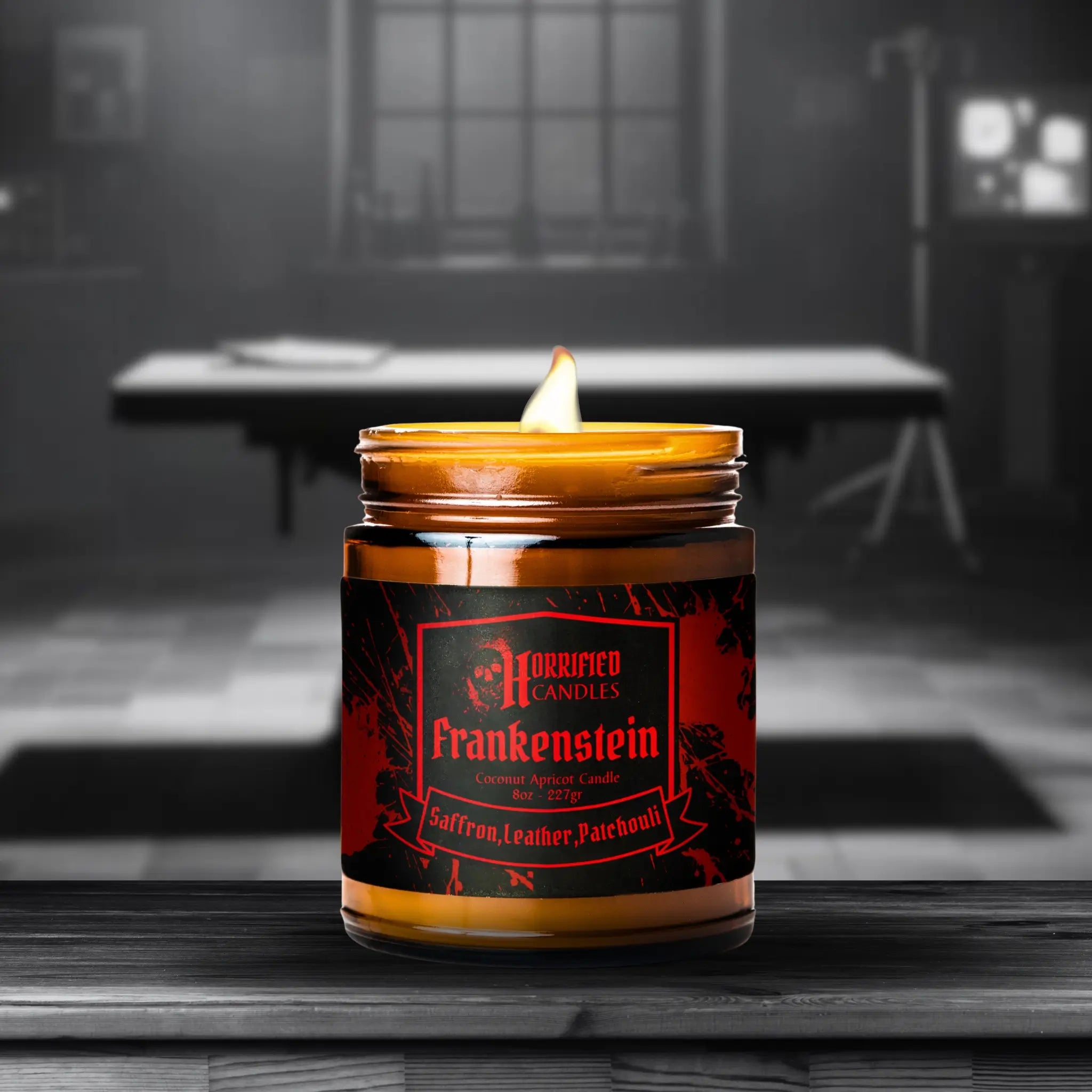 Candle in a jar labeled 'Frankenstein' by Purified Candles on a wooden surface with a dark background.