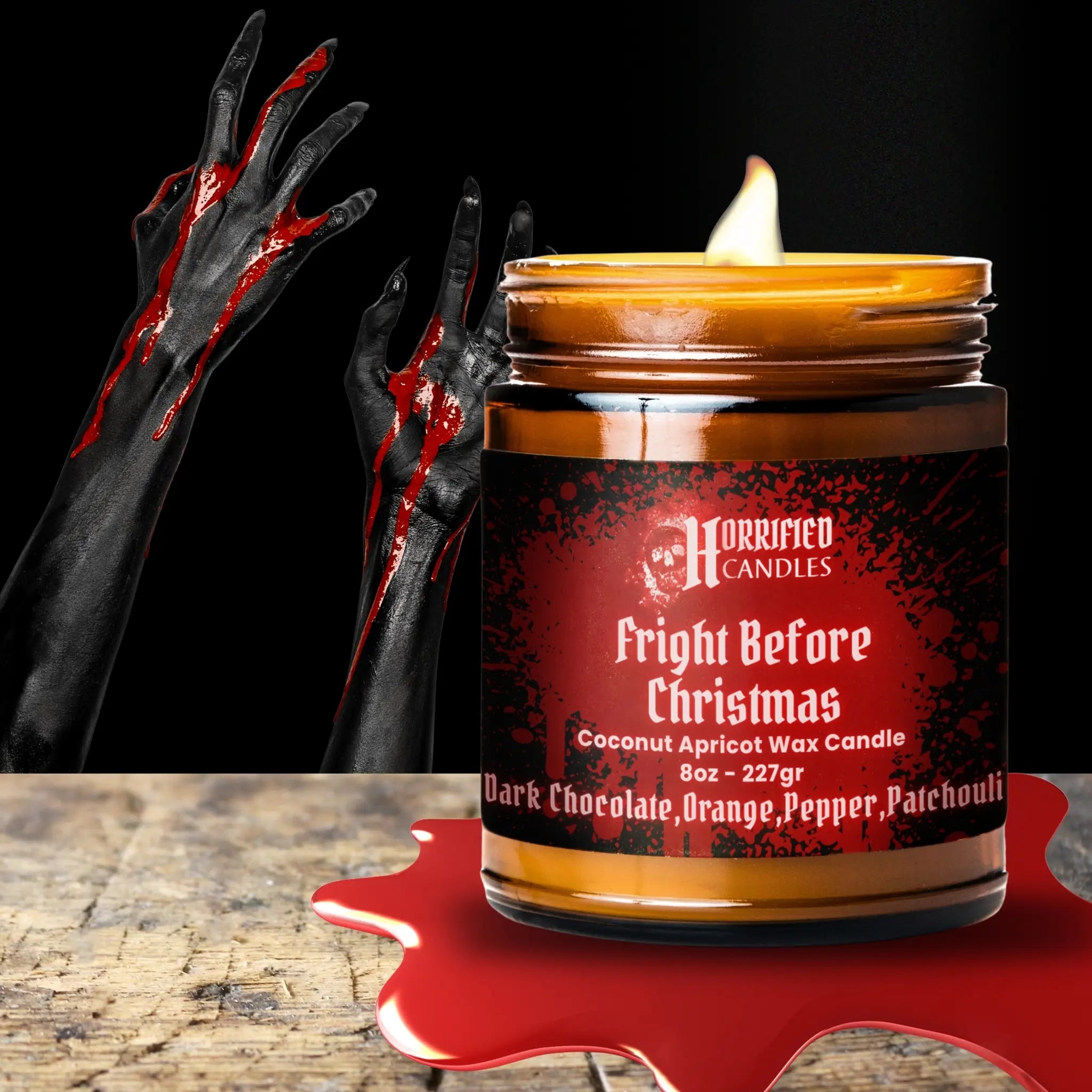 Candle labeled 'Fright Before Christmas' with a dark and eerie design, surrounded by black hands with red stains on a dark background.