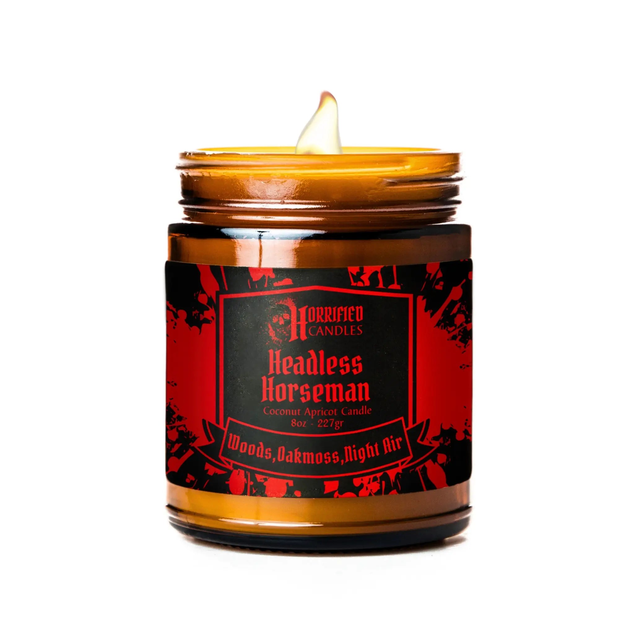 Candle in a glass jar with a red and black label on a white background