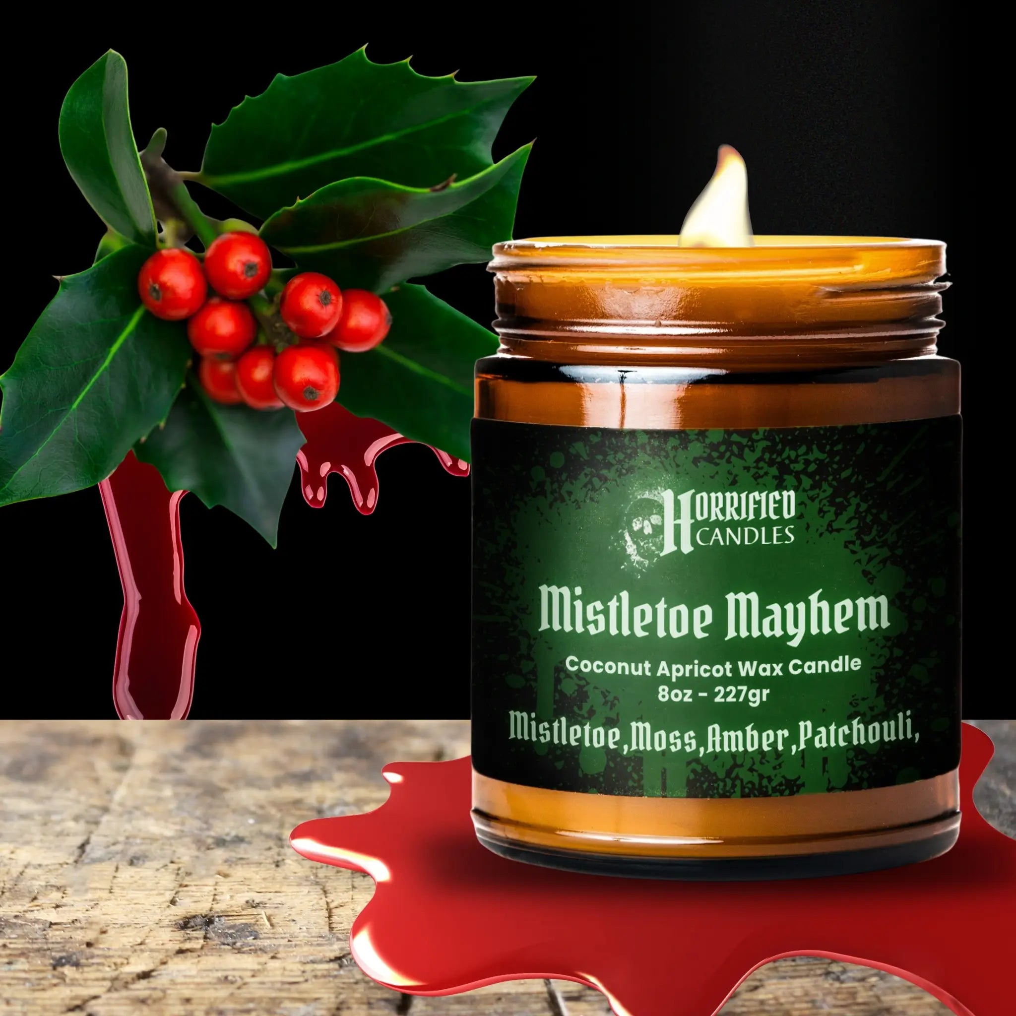 Horrified Candles Mistletoe Mayhem candle with holly leaves and berries on a dark background