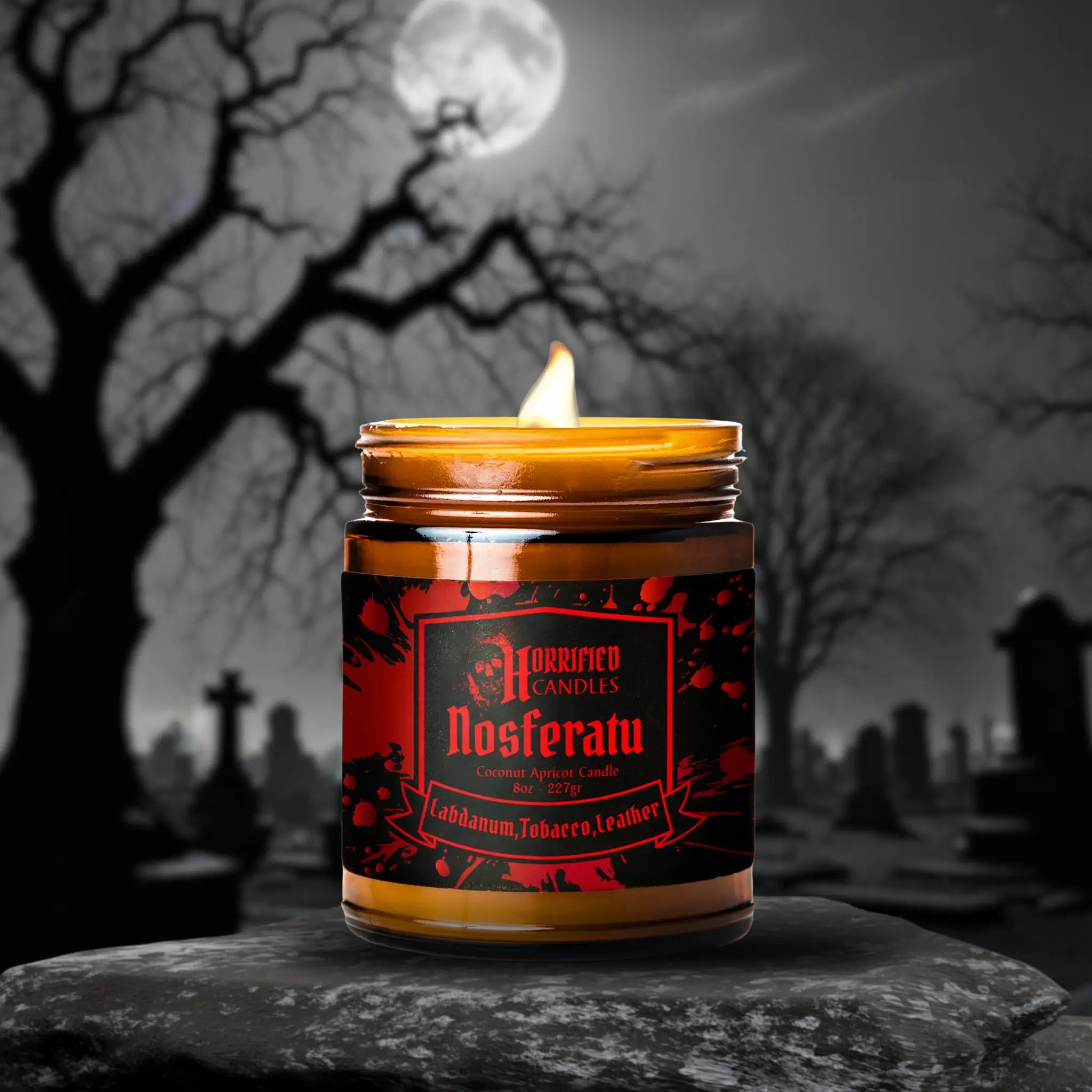 Candle in a jar labeled 'Nosferatu' with a dark, moonlit cemetery background