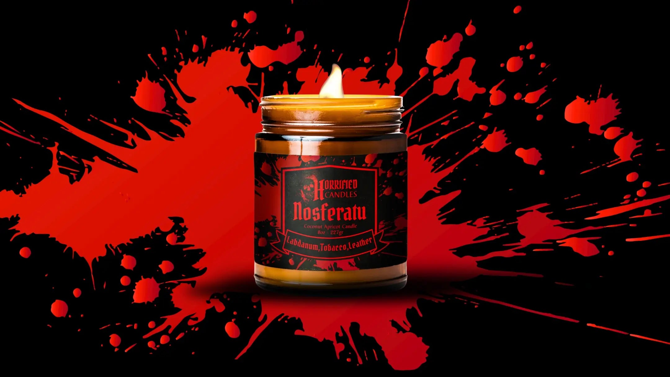 Candle in a jar with a label on a black and red splatter background