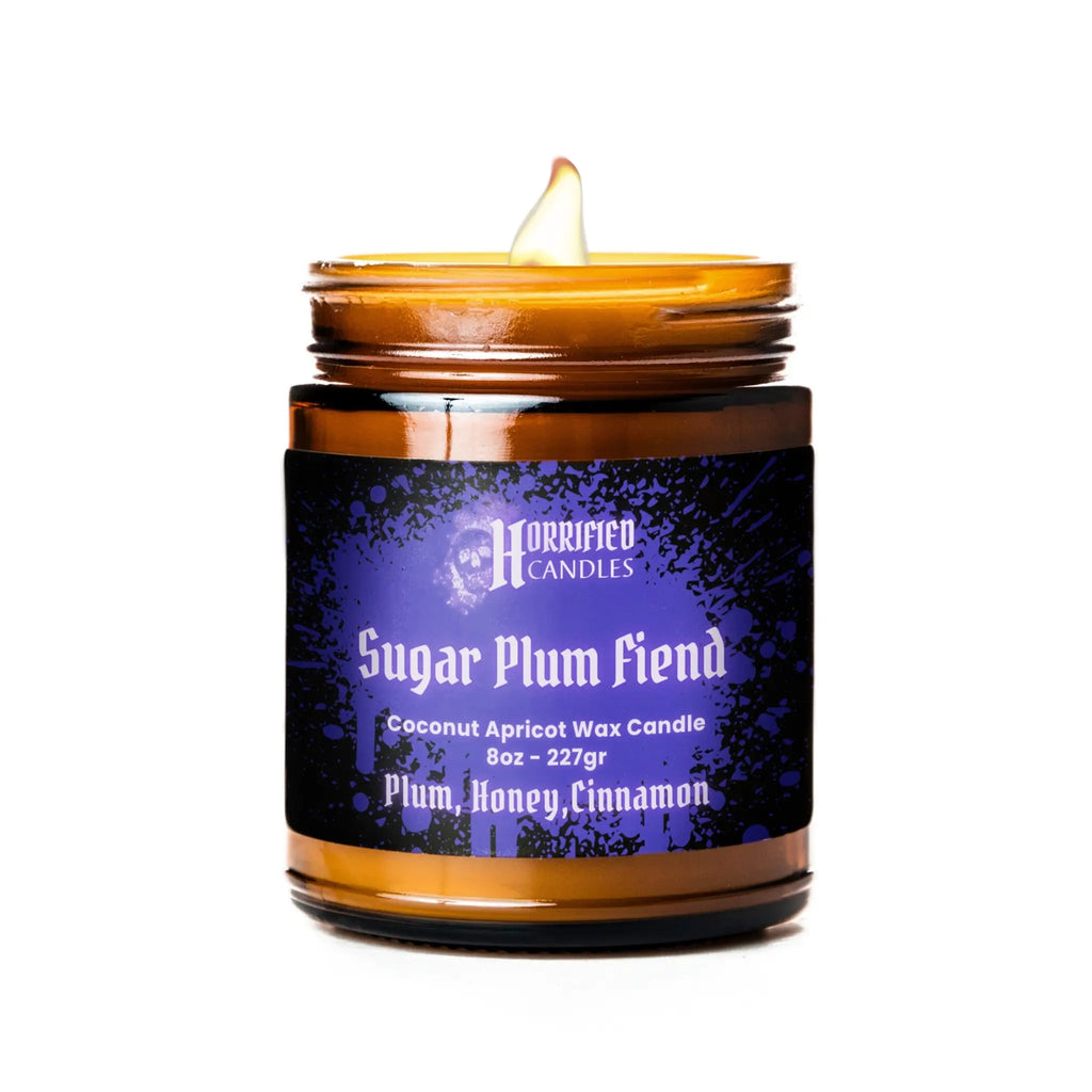 Candle in a glass jar with a purple label on a white background