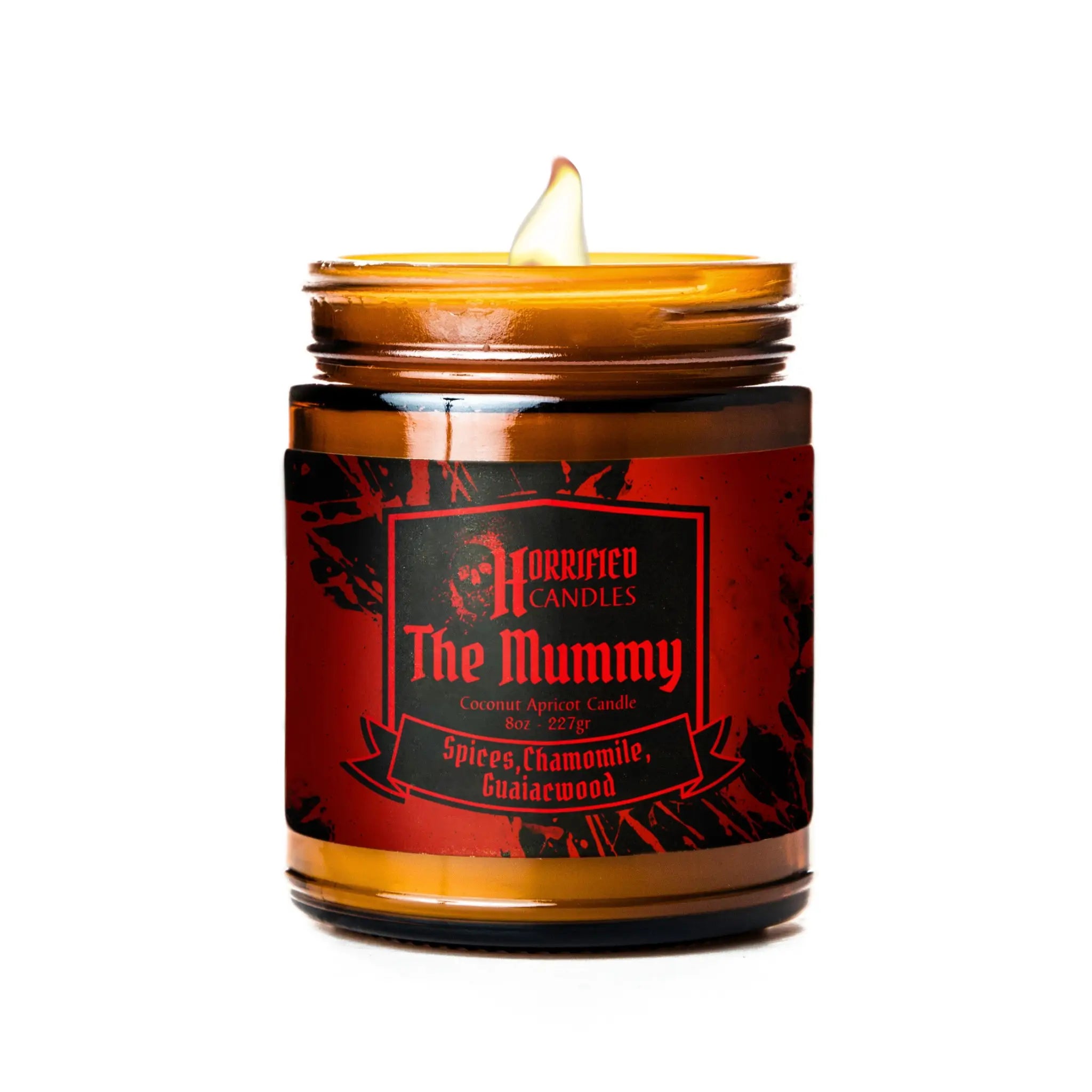 Candle in a glass jar with a red label titled 'The Mummy' on a white background
