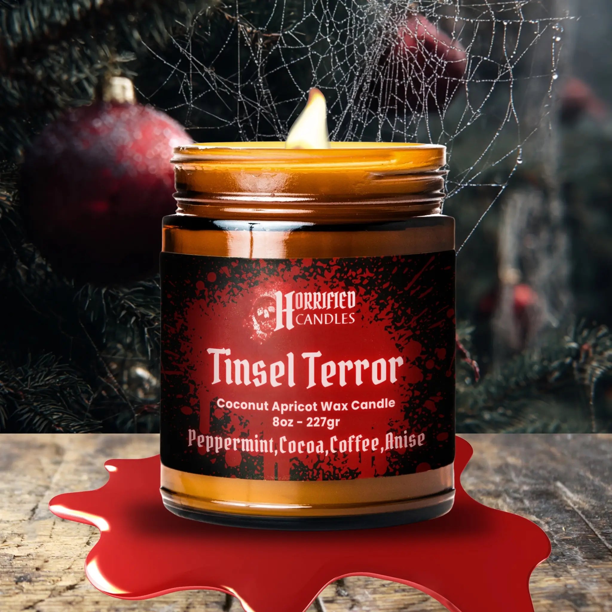 Candle labeled 'Tinsel Terror' from Horrified Candles with a dark background.